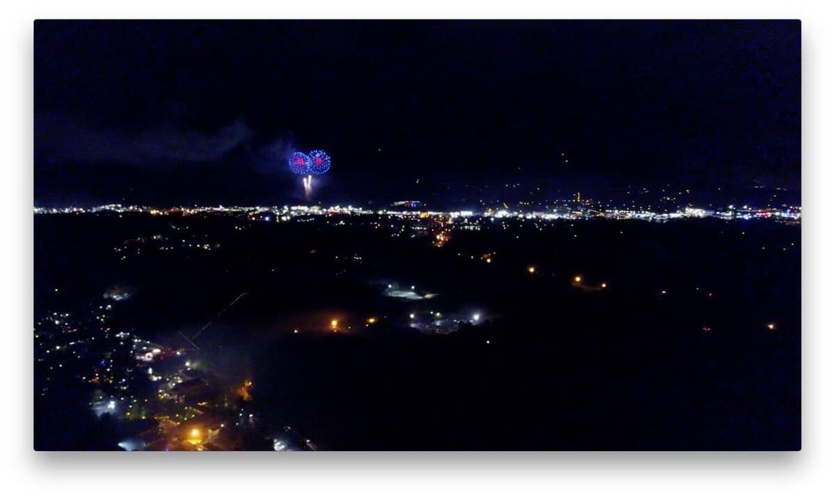 Fourth of July fireworks in red and blue bursting over Pigeon Forge valley visible from the cabin