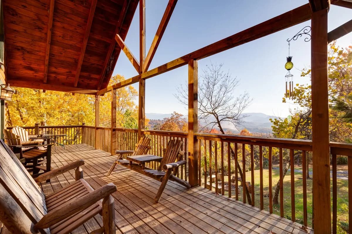 Actual covered deck dining area with a Smoky Mountain view at Thistle Britches.